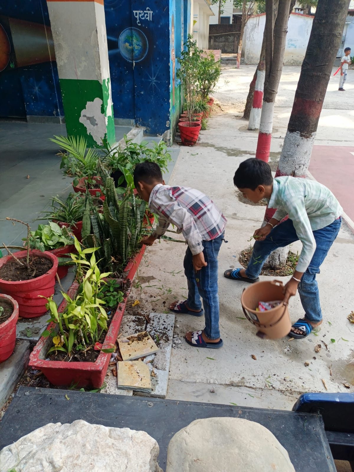 Children caring for plants during an environmental activity